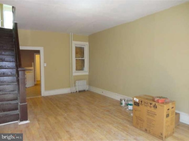 interior space with radiator and light wood-type flooring