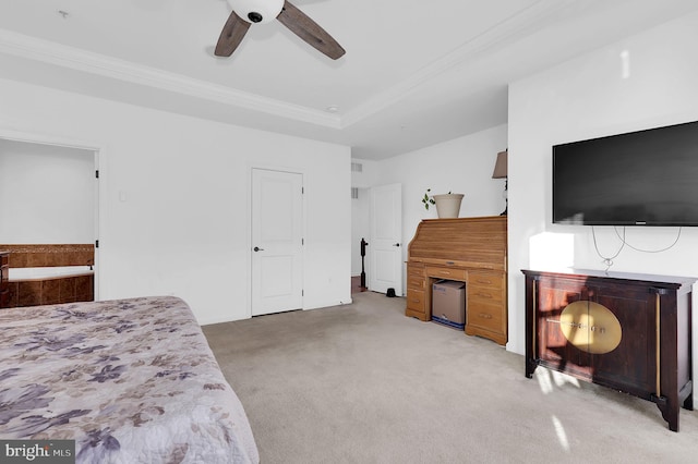 carpeted bedroom featuring crown molding, ceiling fan, and a tray ceiling