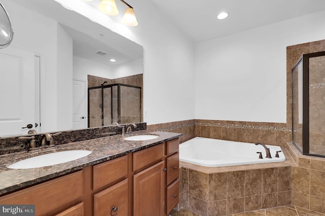 bathroom featuring vanity and shower with separate bathtub