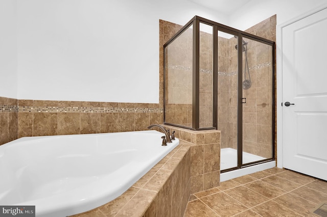 bathroom with tile patterned flooring and independent shower and bath