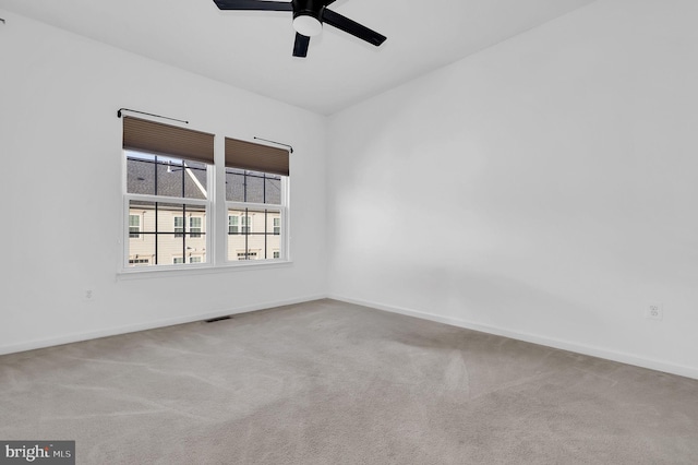 carpeted spare room featuring ceiling fan