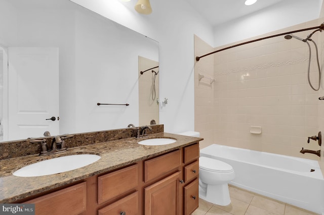 full bathroom featuring vanity, tiled shower / bath combo, tile patterned floors, and toilet