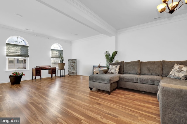 living room featuring wood-type flooring, an inviting chandelier, and crown molding