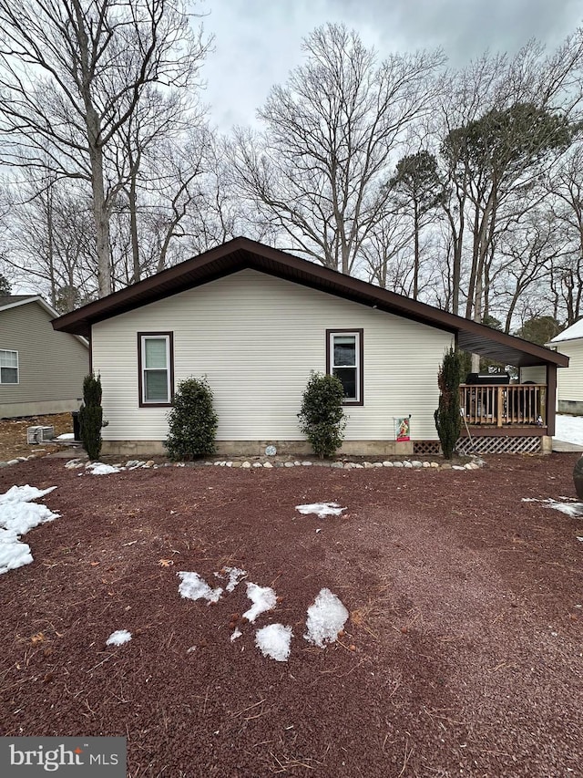 view of side of home with a deck