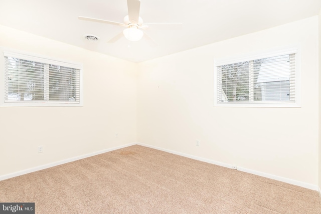 carpeted spare room featuring ceiling fan