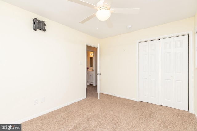 unfurnished bedroom featuring carpet, ceiling fan, and a closet