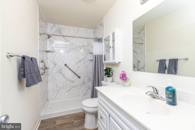 bathroom with vanity, toilet, curtained shower, and wood-type flooring