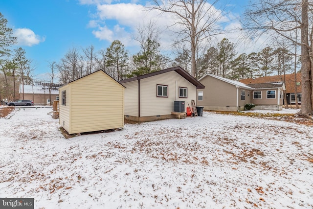 snow covered property featuring central air condition unit