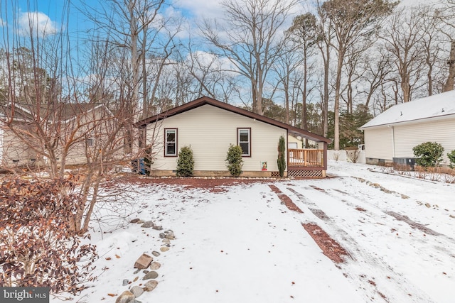 snow covered property with a deck