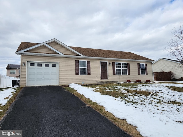 ranch-style house with cooling unit and a garage