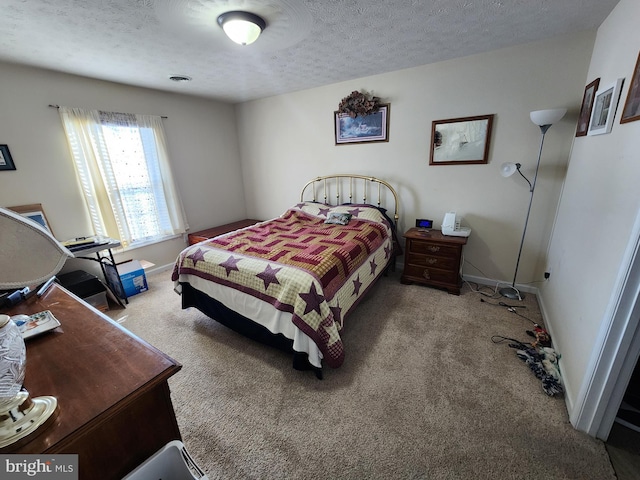 bedroom featuring carpet floors and a textured ceiling