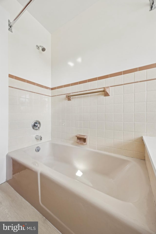 bathroom with tile walls and a washtub