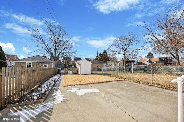 view of yard with a storage unit and a patio area