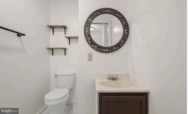 bathroom with toilet and vanity