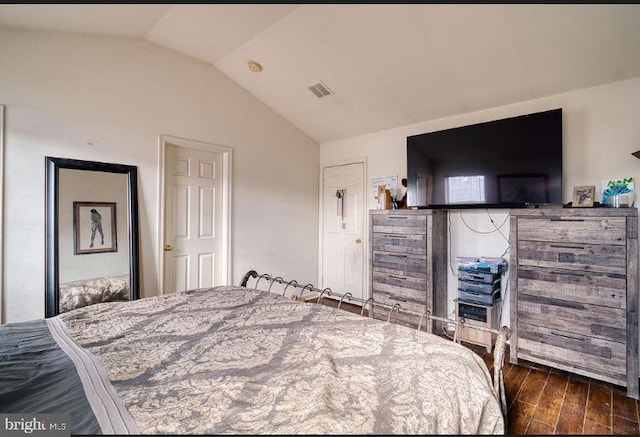 bedroom featuring vaulted ceiling and dark hardwood / wood-style floors