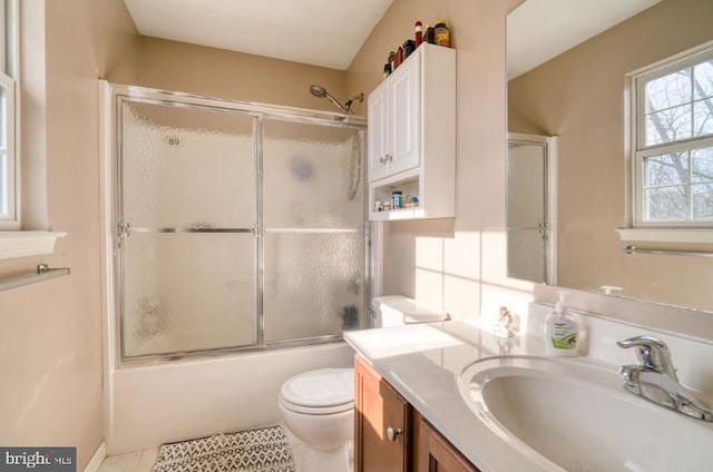 full bathroom with enclosed tub / shower combo, vanity, toilet, and tile patterned floors