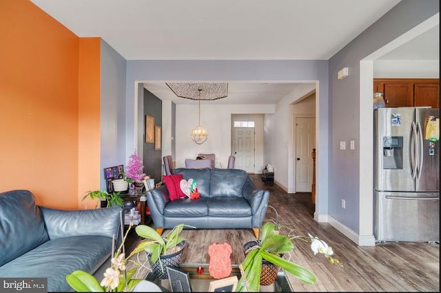 living room with hardwood / wood-style floors and a chandelier