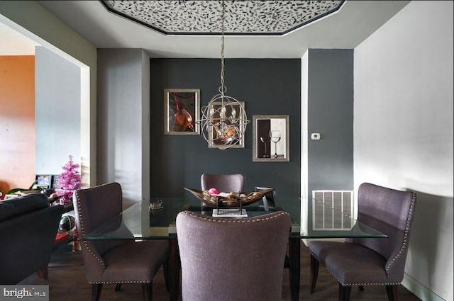 dining room featuring hardwood / wood-style flooring and a chandelier