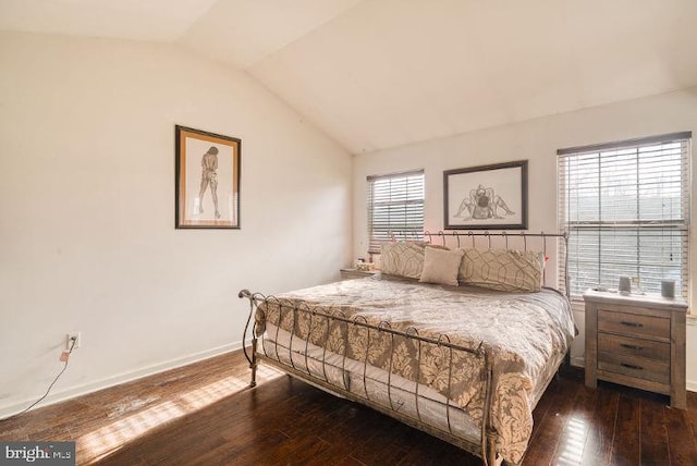 bedroom with lofted ceiling and dark hardwood / wood-style flooring