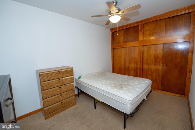 bedroom featuring light carpet and ceiling fan