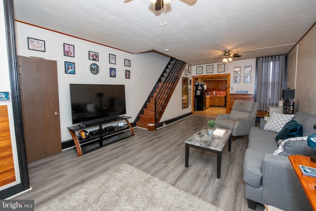 living room featuring ceiling fan and light wood-type flooring