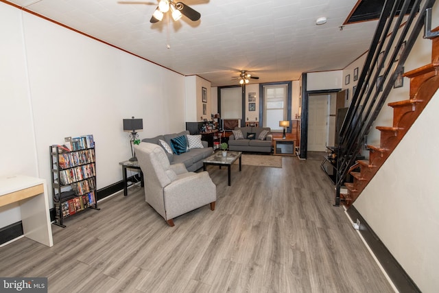 living room with ceiling fan and light hardwood / wood-style floors