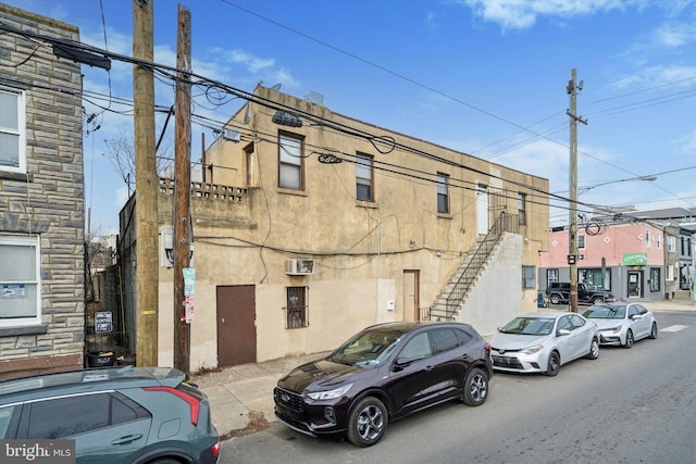 view of building exterior with a wall mounted air conditioner