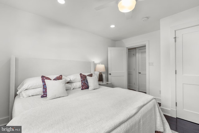 bedroom with ceiling fan and dark hardwood / wood-style flooring