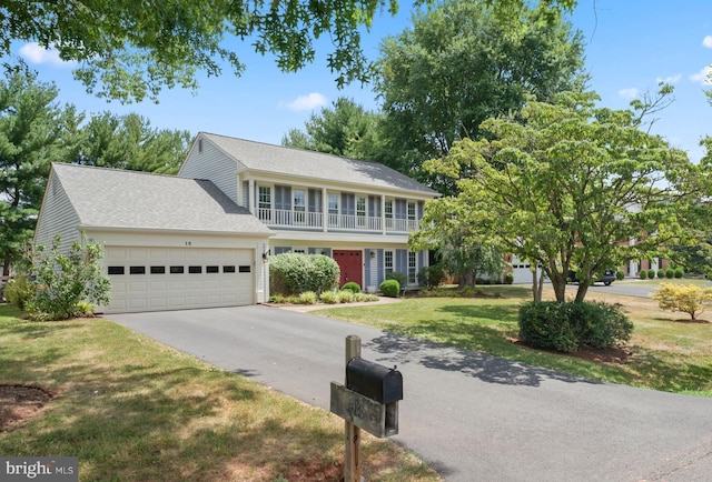 view of front of house featuring a garage and a front lawn