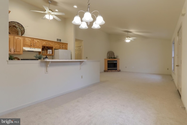 kitchen featuring pendant lighting, light carpet, white fridge, high vaulted ceiling, and a breakfast bar area