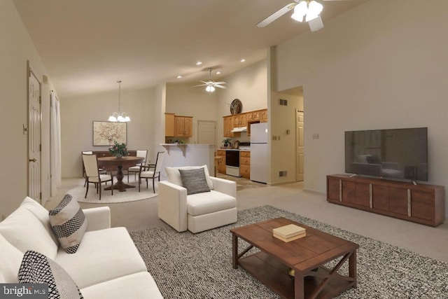 living room with high vaulted ceiling, light colored carpet, and ceiling fan with notable chandelier