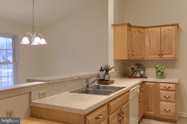 kitchen with light brown cabinets, sink, hanging light fixtures, a notable chandelier, and white dishwasher