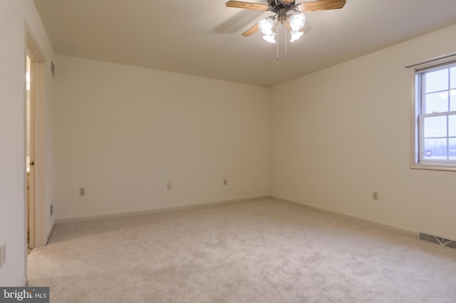 spare room with light carpet and ceiling fan