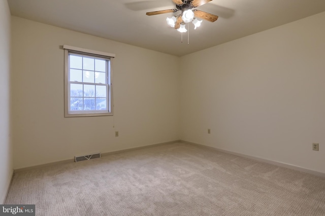 carpeted spare room with ceiling fan