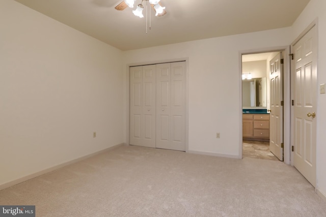 unfurnished bedroom with ceiling fan, light carpet, and a closet