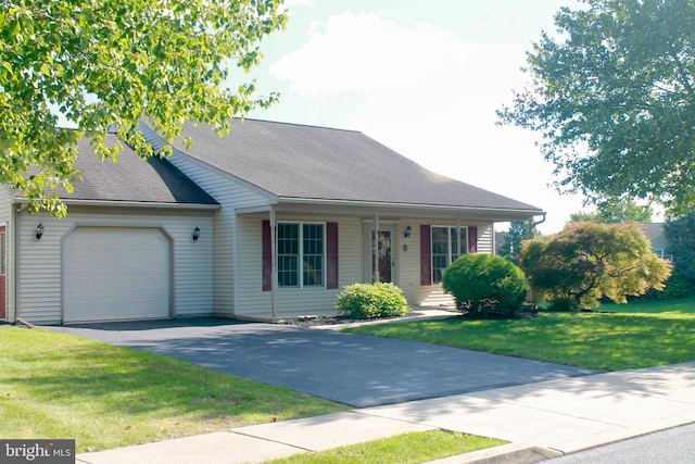 ranch-style home featuring a front lawn and a garage