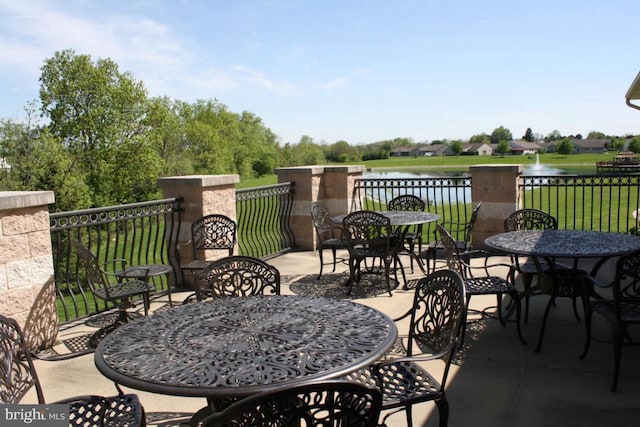 view of patio with a water view