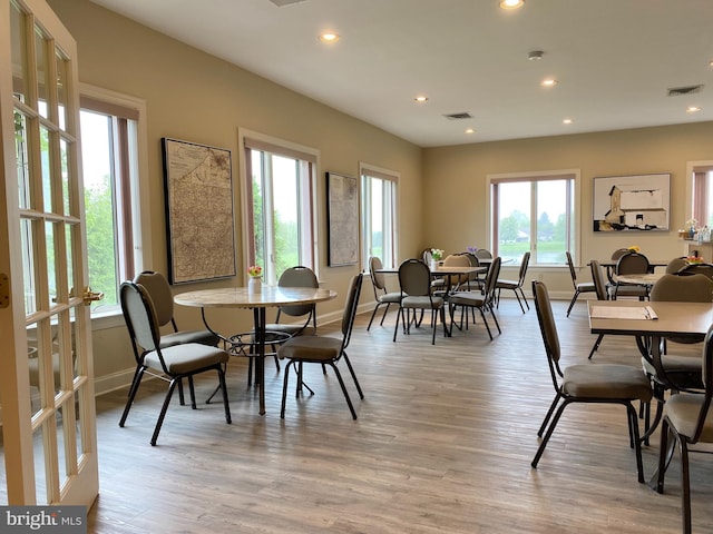 dining area with a healthy amount of sunlight and light hardwood / wood-style flooring