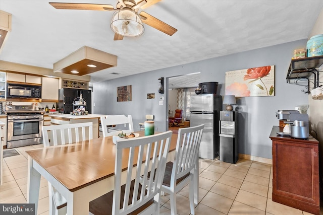 dining area with ceiling fan and light tile patterned floors