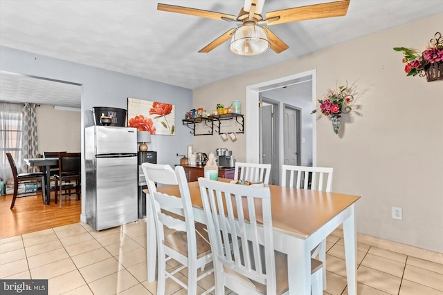 dining area featuring ceiling fan and light tile patterned floors