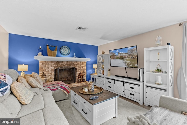 living room featuring a brick fireplace