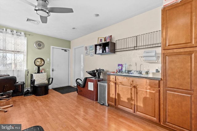 kitchen featuring ceiling fan, light hardwood / wood-style floors, and sink