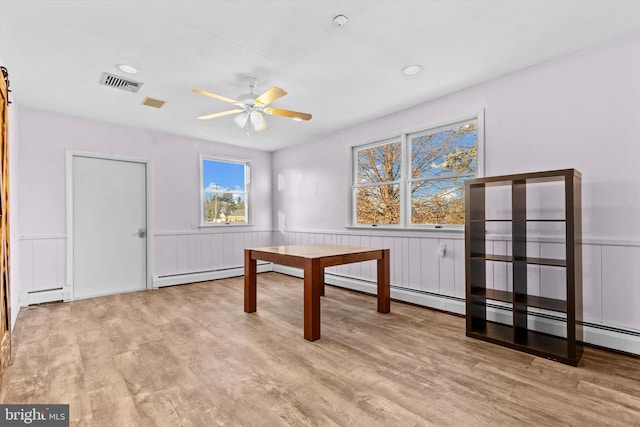 office featuring ceiling fan, a baseboard radiator, and light hardwood / wood-style floors