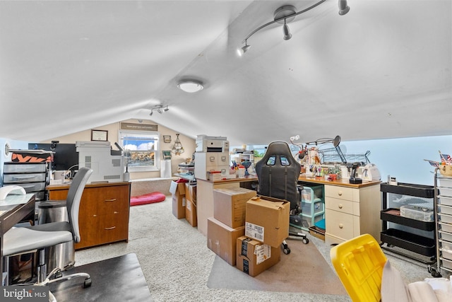 carpeted office space with vaulted ceiling