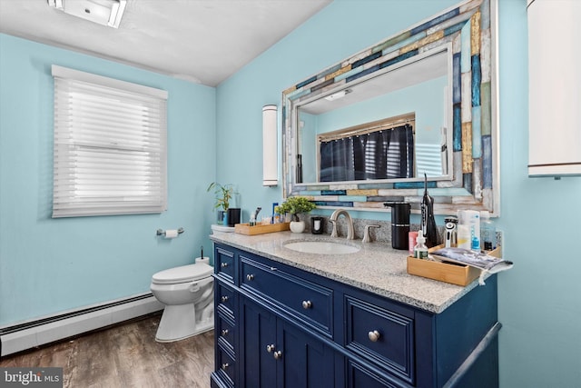 bathroom with baseboard heating, wood-type flooring, toilet, and vanity