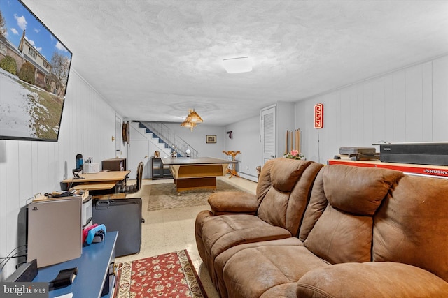 living room with a textured ceiling, pool table, and a baseboard radiator