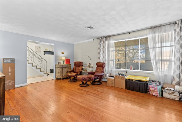 sitting room with a textured ceiling and wood-type flooring