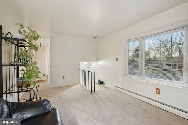 sitting room featuring light colored carpet and baseboard heating