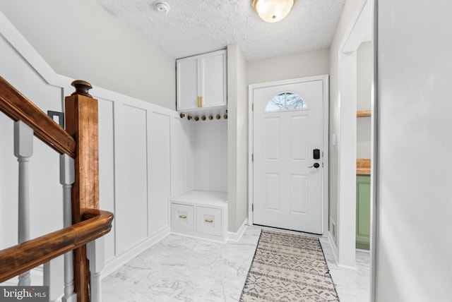 mudroom featuring a textured ceiling