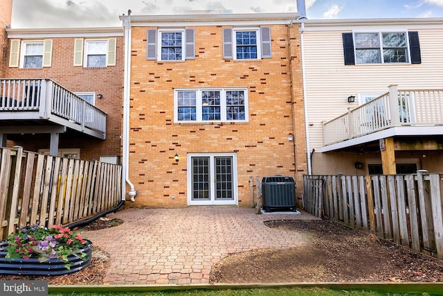 back of property featuring cooling unit and a patio